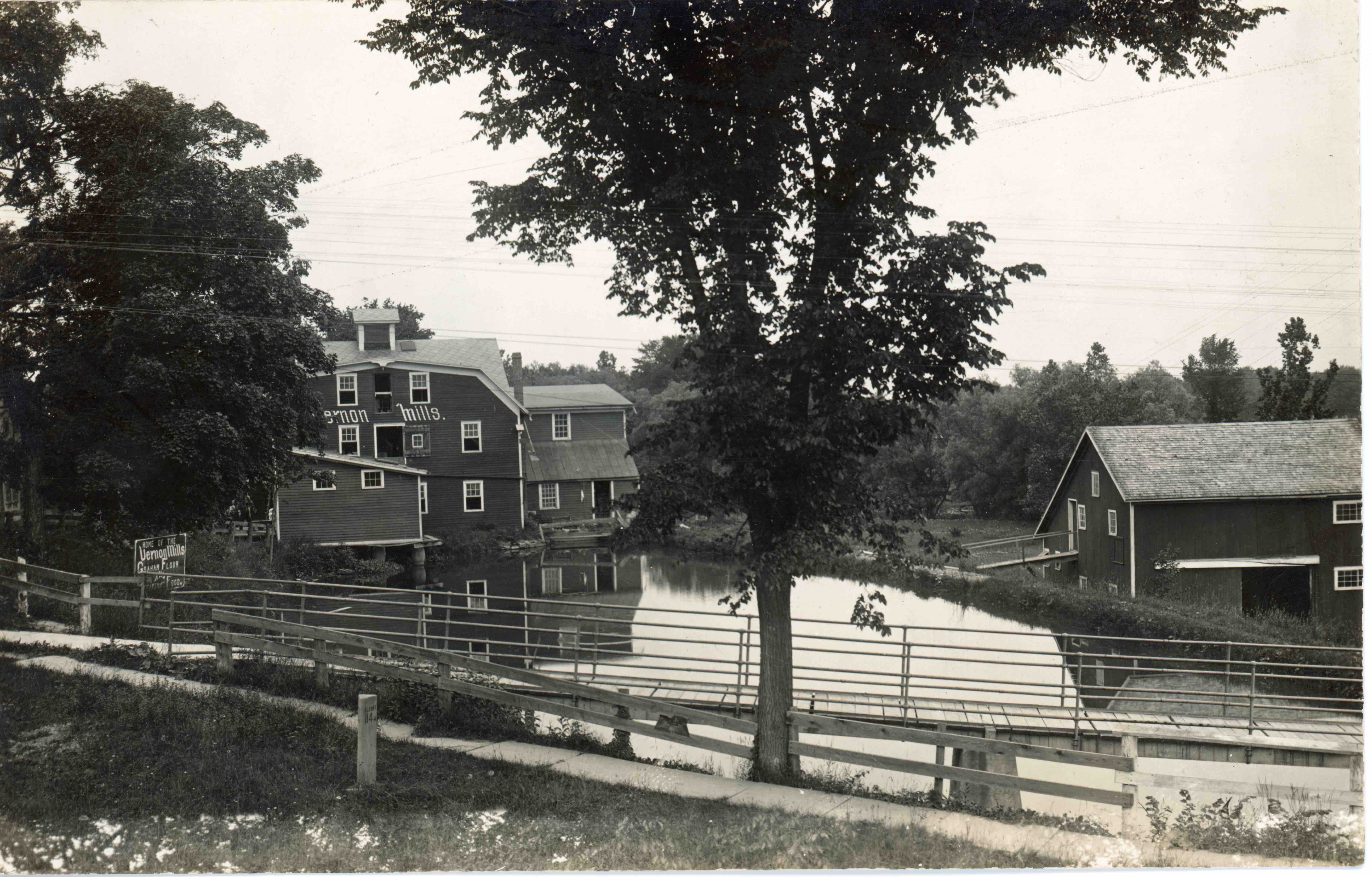 A view of the Vernon mills and mill pond from the road